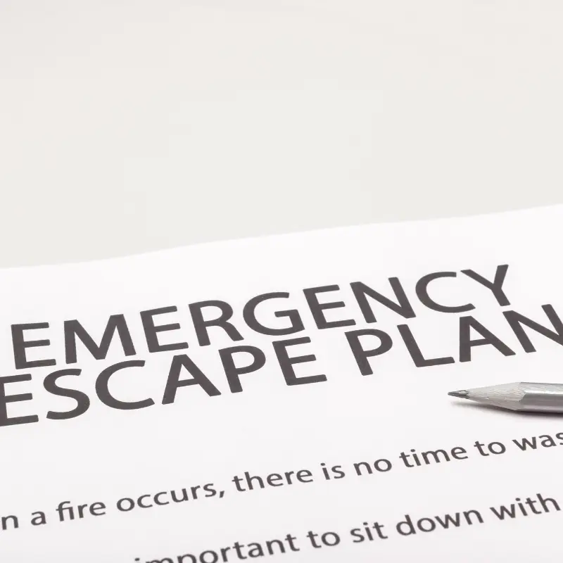 A white sheet of paper reads 'Emergency escape plan'